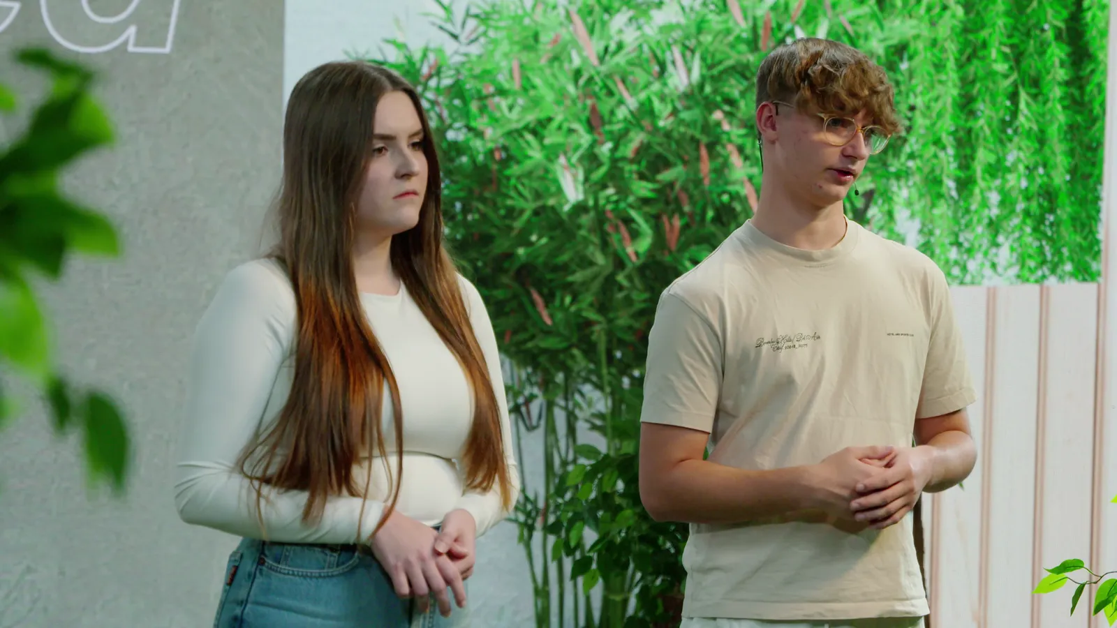 Zwei Moderierende im ruhigen Garten-Set der Undressed-Produktion